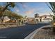 Gated community entrance with desert landscaping and lush foliage at 9548 E Kiva Ln, Gold Canyon, AZ 85118