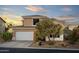 Charming two-story home with a well-manicured front yard and a two-car garage in a desert setting at 9548 E Kiva Ln, Gold Canyon, AZ 85118