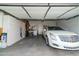 Spacious garage with ample storage cabinets and a white Cadillac at 9548 E Kiva Ln, Gold Canyon, AZ 85118