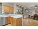 Open concept kitchen featuring white countertops, tile backsplash, stainless steel appliances and view to the dining area at 9548 E Kiva Ln, Gold Canyon, AZ 85118