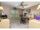 Comfortable home office space with wood desk, ceiling fan, and a view of the outdoors at 9548 E Kiva Ln, Gold Canyon, AZ 85118