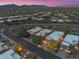 Scenic aerial view of homes in a desert neighborhood with mountains in the distance at 9566 E Raindance Trl, Scottsdale, AZ 85262
