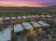 Scenic aerial view of a residential community nestled near a golf course at sunset at 9566 E Raindance Trl, Scottsdale, AZ 85262
