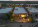 Dusk aerial shot featuring fenced patio with lighting and outdoor furniture at 9566 E Raindance Trl, Scottsdale, AZ 85262