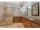 Well-lit bathroom with tiled shower and dual sink vanity at 9566 E Raindance Trl, Scottsdale, AZ 85262