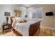 Cozy bedroom with wood floors, side table with lamp, and large window for plenty of natural light at 9566 E Raindance Trl, Scottsdale, AZ 85262