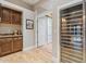 Dining area with bar, wine fridge, cabinets, and an open doorway to a hallway at 9566 E Raindance Trl, Scottsdale, AZ 85262