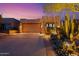 Exterior of home with three-car garage featuring well-maintained landscaping and desert plants at 9566 E Raindance Trl, Scottsdale, AZ 85262