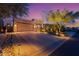 Inviting exterior of home with desert landscaping, a three-car garage, and plenty of parking space at 9566 E Raindance Trl, Scottsdale, AZ 85262