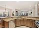 Well-appointed kitchen with granite counters, stainless appliances, and a spacious open layout to the living room at 9566 E Raindance Trl, Scottsdale, AZ 85262