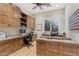 Home office with built-in desk, cabinetry, and a comfortable workspace at 9566 E Raindance Trl, Scottsdale, AZ 85262