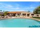 Inviting backyard with a pool, patio, and lush greenery, perfect for outdoor relaxation and entertaining at 9849 E Topaz Dr, Scottsdale, AZ 85258