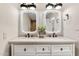 Bathroom with double sinks, decorative mirrors, and elegant fixtures at 9849 E Topaz Dr, Scottsdale, AZ 85258