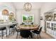 Cozy dining room with a rustic wood table, stylish lighting, and ample natural light at 9849 E Topaz Dr, Scottsdale, AZ 85258