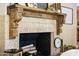 Close-up of the fireplace with custom tile work, a decorative mantle, and a cozy ambiance at 9849 E Topaz Dr, Scottsdale, AZ 85258