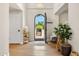 Bright foyer featuring hardwood floors, an arched doorway, and access to the front yard at 9849 E Topaz Dr, Scottsdale, AZ 85258