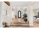 Bright foyer with hardwood floors, a decorative chandelier, and an arched doorway at 9849 E Topaz Dr, Scottsdale, AZ 85258
