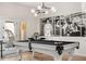 Game room features a pool table, stylish lighting, and black and white decor with access to the outdoors at 9849 E Topaz Dr, Scottsdale, AZ 85258