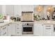 This kitchen features white cabinetry, stainless steel appliances, and stylish lighting at 9849 E Topaz Dr, Scottsdale, AZ 85258