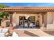 Covered patio with outdoor dining table, modern chandelier, and access to pool, creating an ideal space for entertaining guests at 9849 E Topaz Dr, Scottsdale, AZ 85258