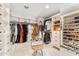 Spacious walk-in closet with custom shelving, drawers, and ample storage for clothes and shoes at 9849 E Topaz Dr, Scottsdale, AZ 85258