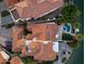 Aerial view of a luxurious desert waterfront home featuring a tile roof and a private pool and patio at 1700 E Lakeside Dr # 12, Gilbert, AZ 85234