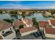 Stunning aerial view of waterfront homes with tile roofs, lush landscaping, and access to a serene lake community at 1700 E Lakeside Dr # 12, Gilbert, AZ 85234