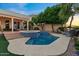 Backyard features a pool, spa, firepit, and cozy outdoor seating at 1700 E Lakeside Dr # 12, Gilbert, AZ 85234
