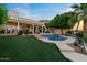 Backyard features a pool, spa, manicured landscaping, and outdoor seating at 1700 E Lakeside Dr # 12, Gilbert, AZ 85234