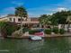 Waterfront home featuring a private backyard with covered patio, jacuzzi, lush greenery, and a boat dock at 1700 E Lakeside Dr # 12, Gilbert, AZ 85234