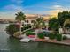 Beautiful backyard on the water with a private dock, pool, desert landscaping, and covered patio at 1700 E Lakeside Dr # 12, Gilbert, AZ 85234