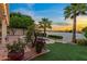 Lakeside backyard featuring lush tropical landscaping, manicured lawn and calming water features at 1700 E Lakeside Dr # 12, Gilbert, AZ 85234