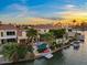 Stunning waterfront backyard featuring a pool, boat dock, lush landscaping, and desert sunset views at 1700 E Lakeside Dr # 12, Gilbert, AZ 85234