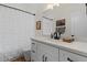 A bathroom featuring white cabinets, a dark faucet and framed pictures hung on the wall at 1700 E Lakeside Dr # 12, Gilbert, AZ 85234