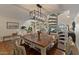 Warm dining room with hardwood floors, natural light, and adjacent spiral staircase at 1700 E Lakeside Dr # 12, Gilbert, AZ 85234