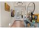 Bright foyer with hardwood floors, decorative mirror, console table, and an ornate front door at 1700 E Lakeside Dr # 12, Gilbert, AZ 85234