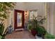Elegant front door with decorative glass, surrounded by lush potted plants and a brick walkway at 1700 E Lakeside Dr # 12, Gilbert, AZ 85234