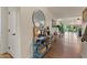 Hallway with hardwood floors, console table, decorative items, and a view of the outdoor living area at 1700 E Lakeside Dr # 12, Gilbert, AZ 85234