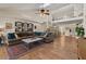 Open-concept living area with stylish furniture, spiral staircase, and wood flooring at 1700 E Lakeside Dr # 12, Gilbert, AZ 85234