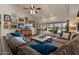 Bright living room with large sectional, marble coffee table, and sliding doors to the patio at 1700 E Lakeside Dr # 12, Gilbert, AZ 85234