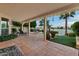 Covered outdoor patio with lounge chairs, string lights, and scenic views of the lake at 1700 E Lakeside Dr # 12, Gilbert, AZ 85234