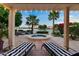 Relaxing outdoor patio with lounge chairs, spa, palm trees, and a beautiful lake view at 1700 E Lakeside Dr # 12, Gilbert, AZ 85234