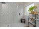 Walk in shower with white herringbone pattern and a wooden stool on a black and white tile floor at 1700 E Lakeside Dr # 12, Gilbert, AZ 85234