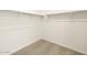 Walk-in closet featuring ample storage space with neutral carpet and paint at 17425 W Eva St, Waddell, AZ 85355