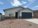 Charming single-story home features a two-car garage and low maintenance front yard at 17425 W Eva St, Waddell, AZ 85355