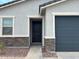 Inviting home entrance features a dark door and low maintenance rock landscaping at 17425 W Eva St, Waddell, AZ 85355