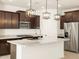 Modern kitchen features stainless steel appliances, pendant lighting, and a spacious island at 17425 W Eva St, Waddell, AZ 85355