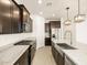 Spacious open concept kitchen features stainless steel appliances, island, and breakfast bar at 17425 W Eva St, Waddell, AZ 85355