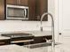 Close up on kitchen features stainless steel appliances and granite countertops at 17425 W Eva St, Waddell, AZ 85355