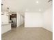 Open-concept living space leading to modern kitchen with stainless steel appliances at 17425 W Eva St, Waddell, AZ 85355